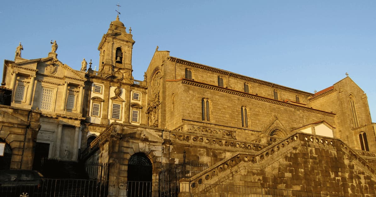 Historic Porto cathedral facade bathed in warm golden light