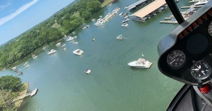 Aerial view of Grand Lake marina and boats from helicopter cockpit