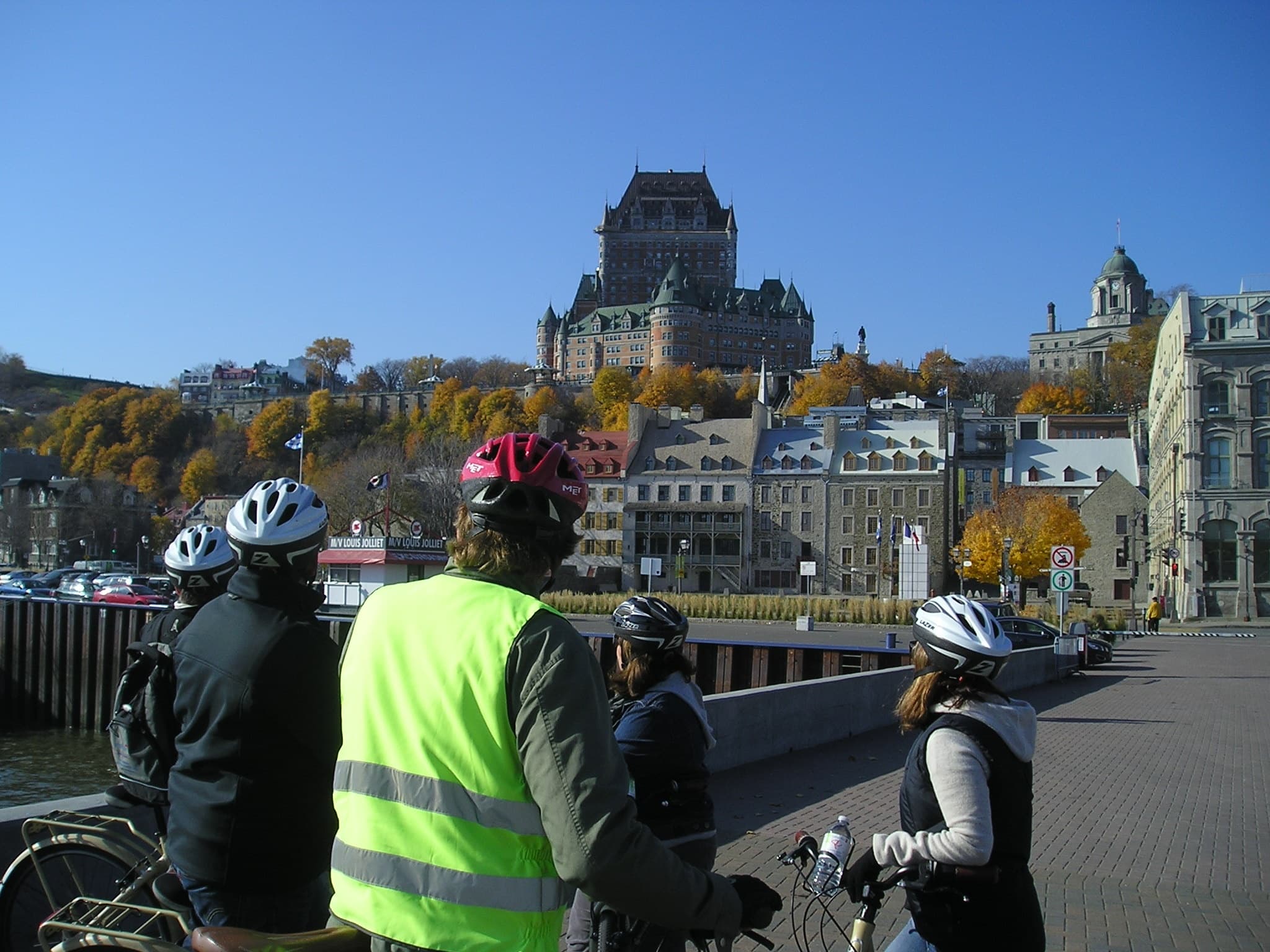 Cyclists touring historic Quebec City streets with château backdrop