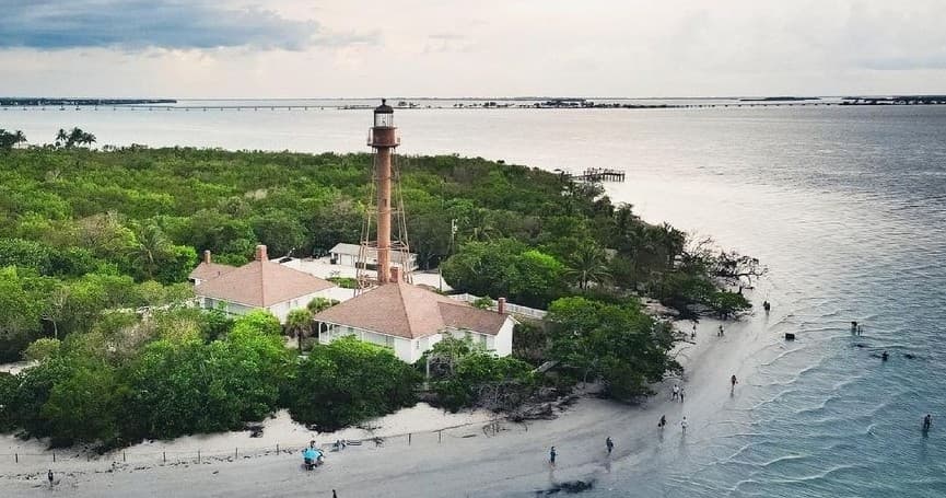 Historic lighthouse on coastal island with beach access