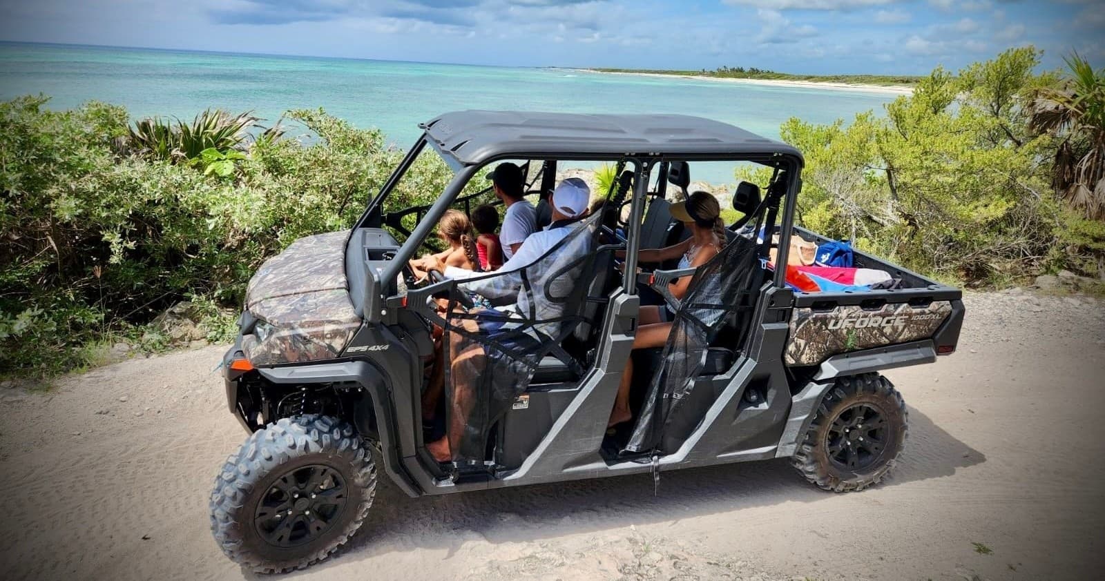 Off-road UTV tour driving along sandy coastal trail in Cozumel