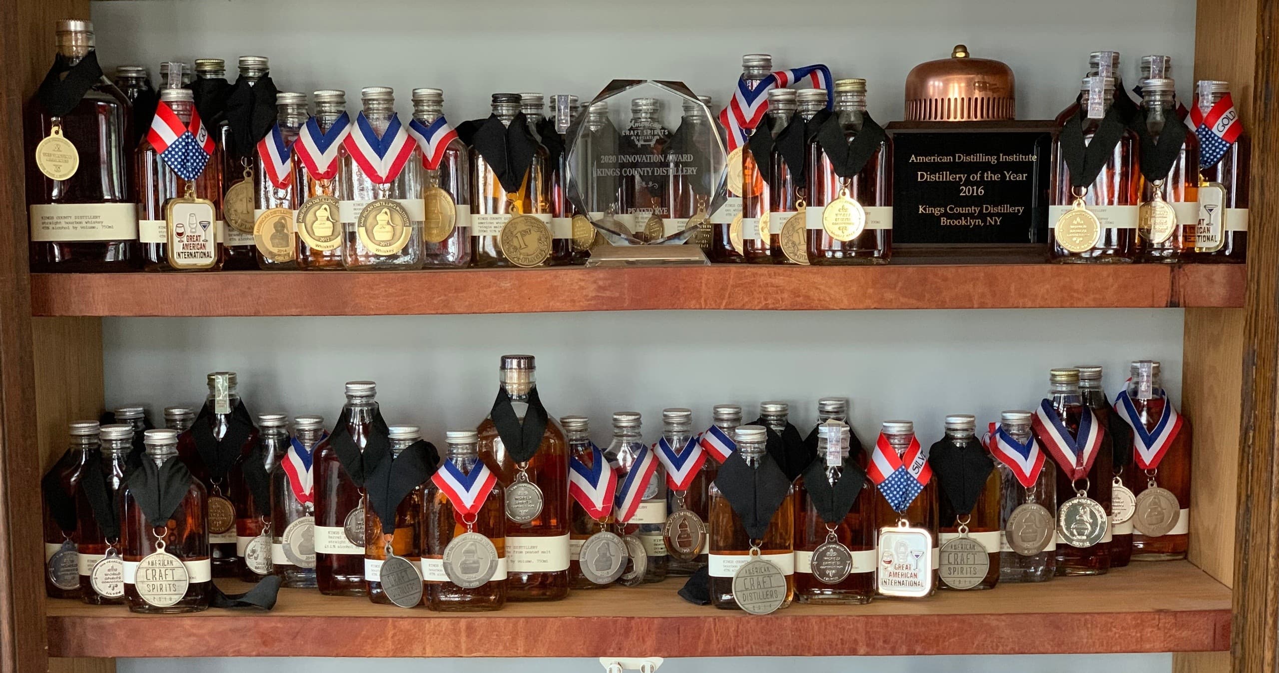Award-winning whiskey bottles displayed on indoor tasting shelf