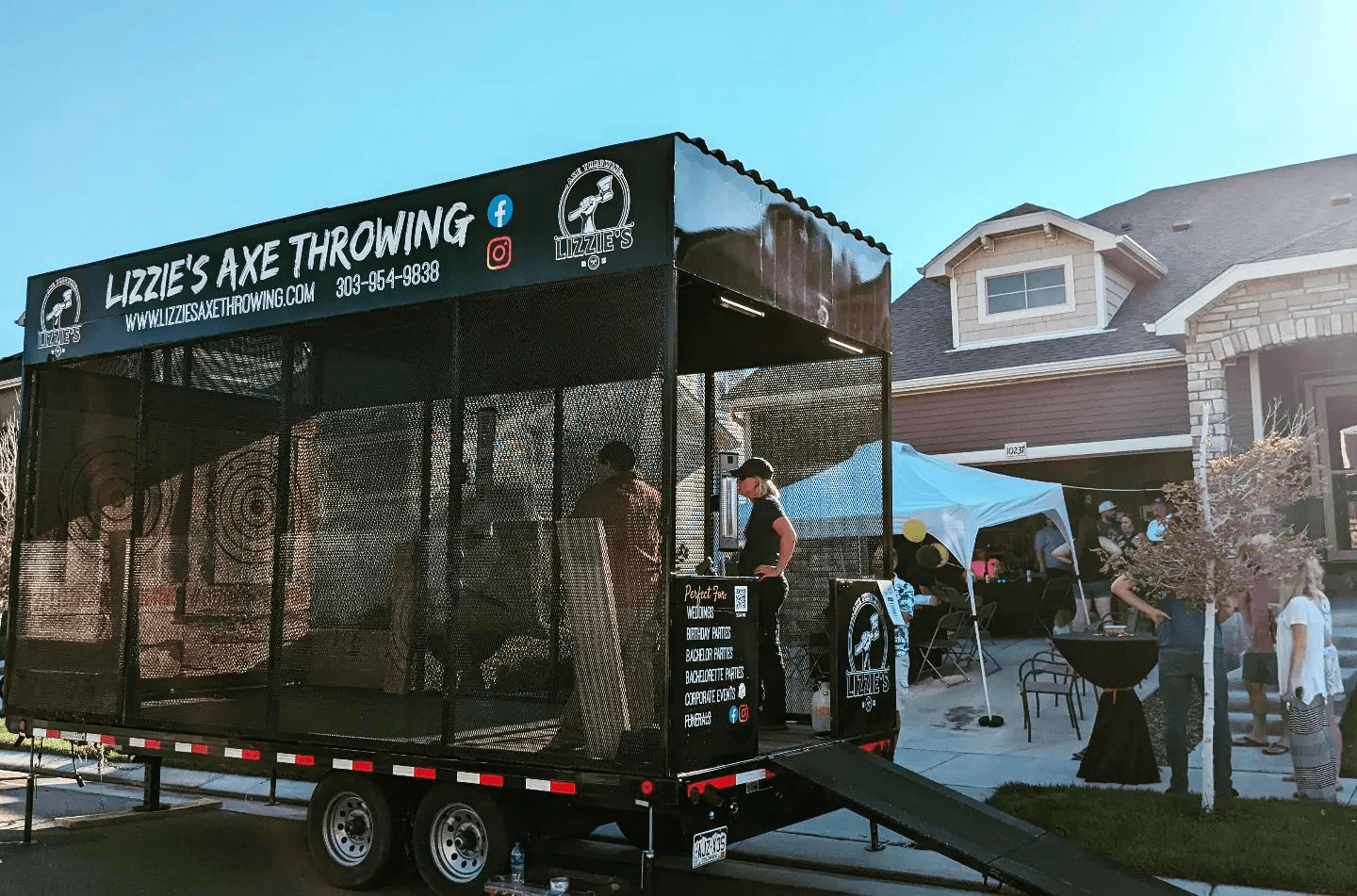 Mobile axe throwing trailer parked at outdoor event