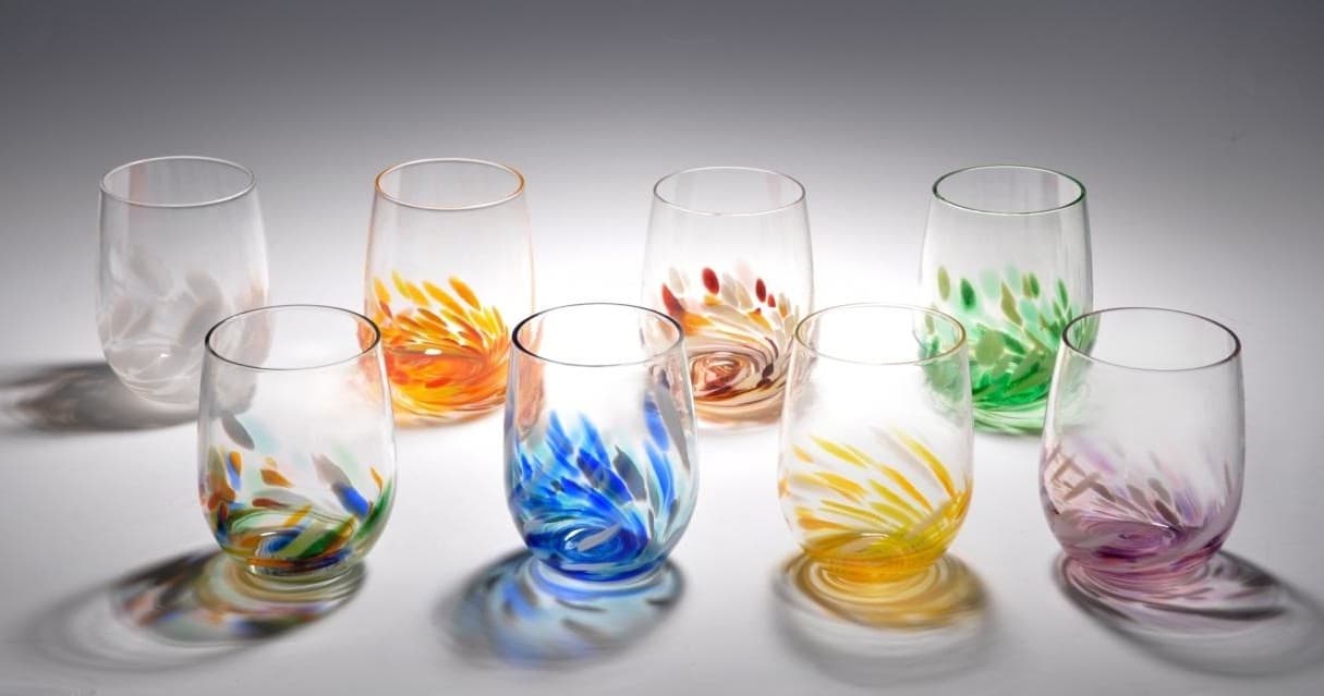 Colorful handblown glasses on white studio table for tasting