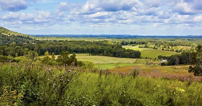 Scenic rolling valley and farmland view at Short Mountain Distillery