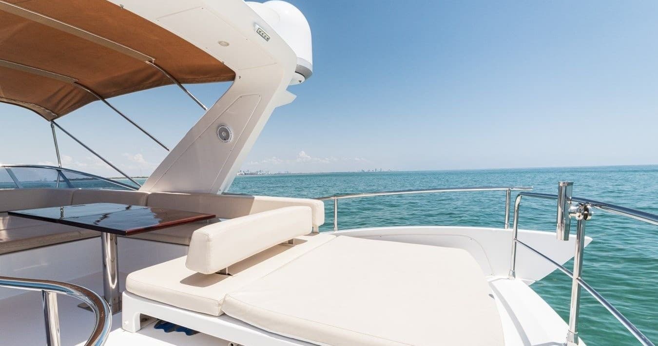 Luxury yacht cruising on turquoise open sea, sunlit deck lounging