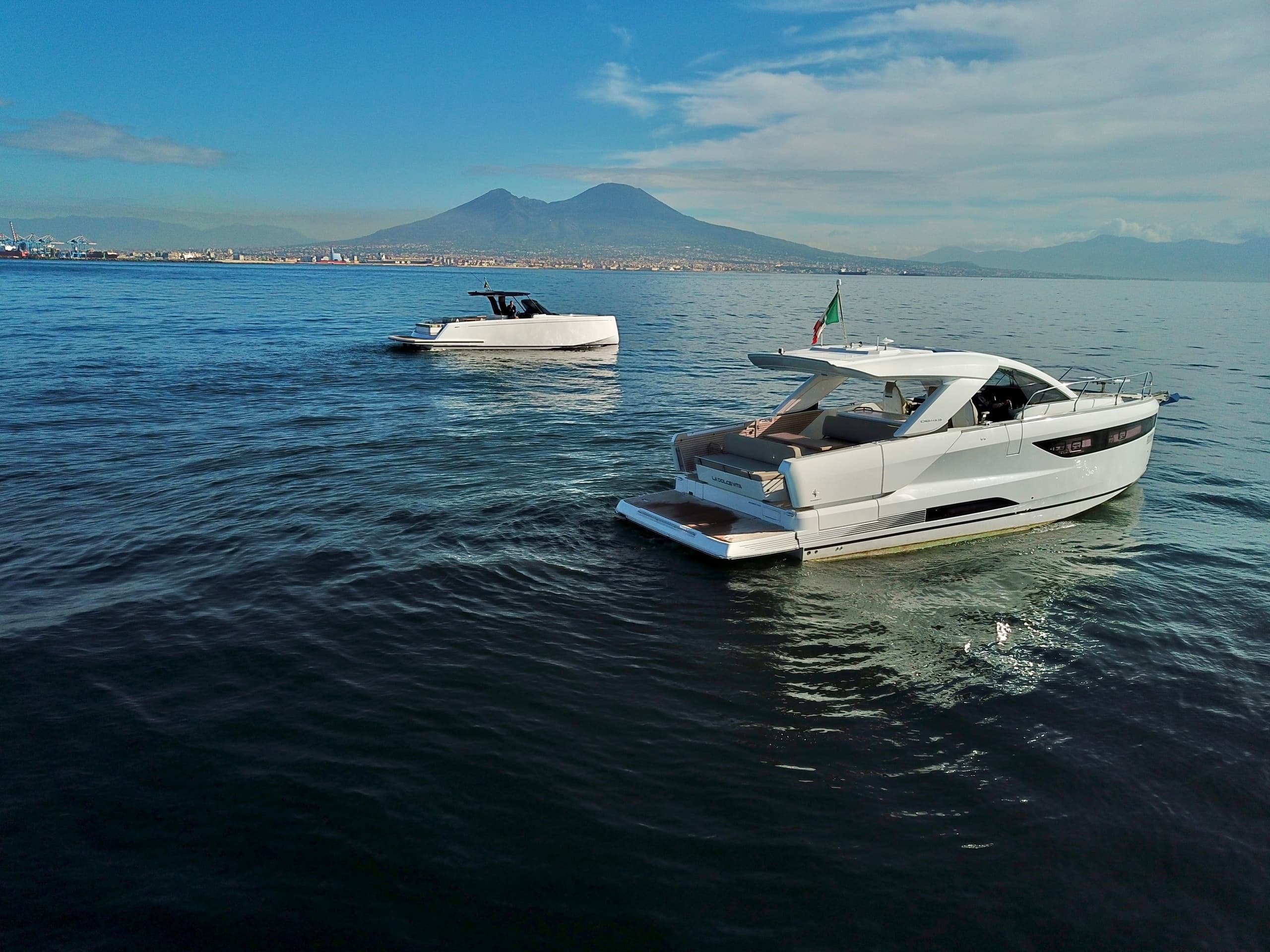 Motorboats cruising near Naples with Vesuvius skyline backdrop