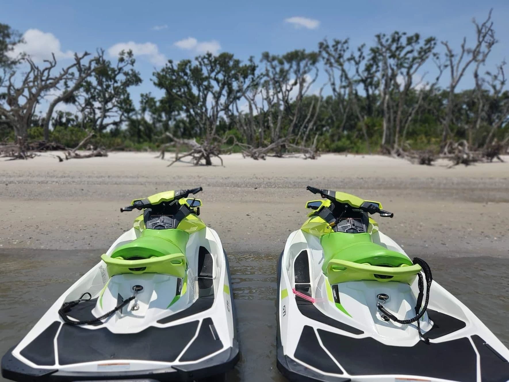 Two jet skis beached on Amelia Island shoreline for rentals