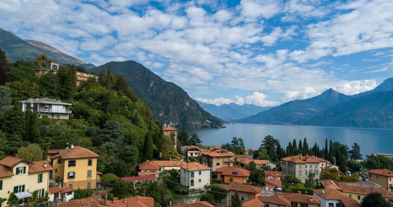 Hilltop village overlooking serene mountain lake and trails