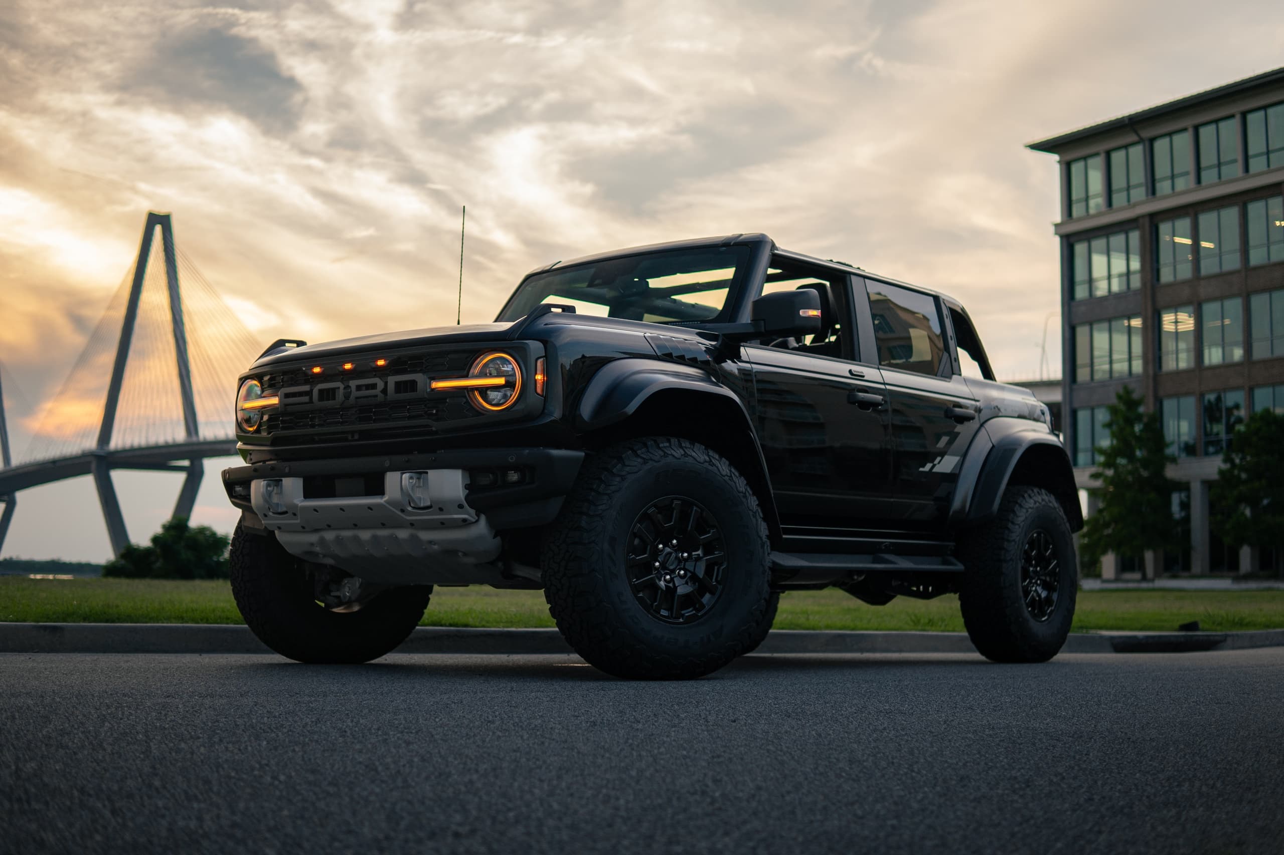 Ford Bronco parked by Ravenel Bridge at sunset, coastal drive