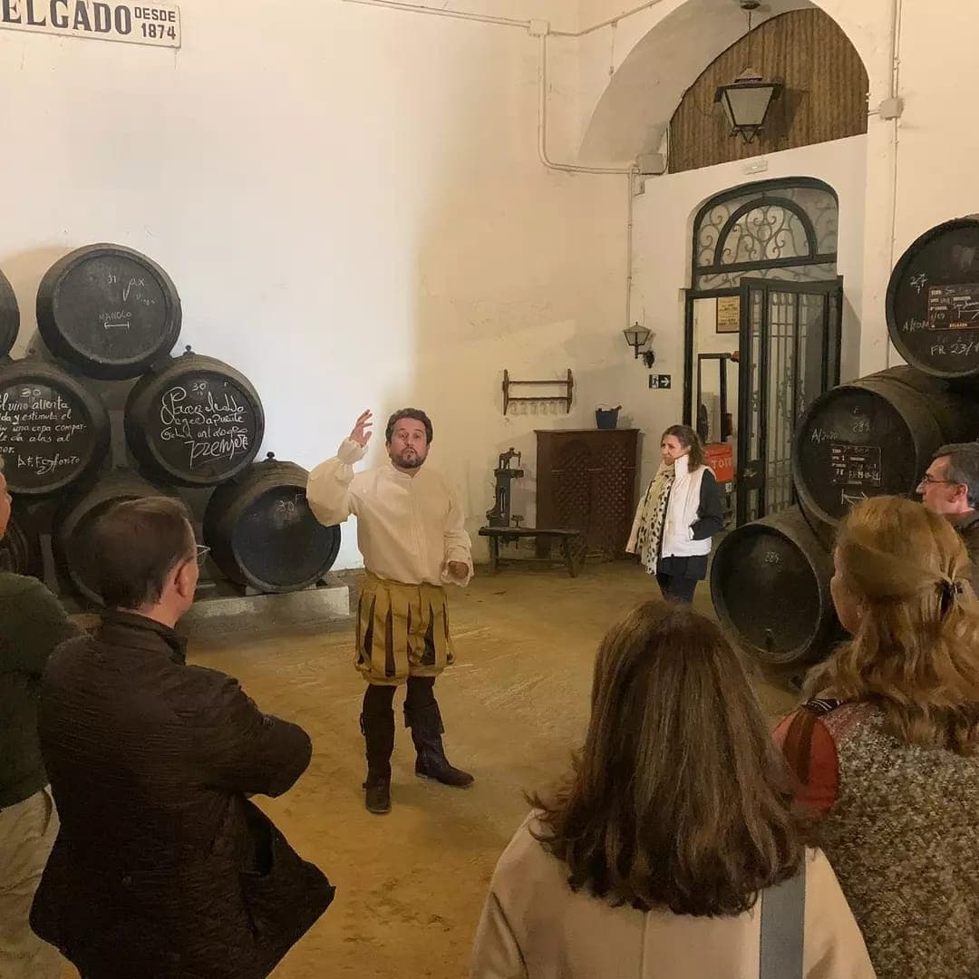 Small-group cellar tour with guide among oak wine barrels