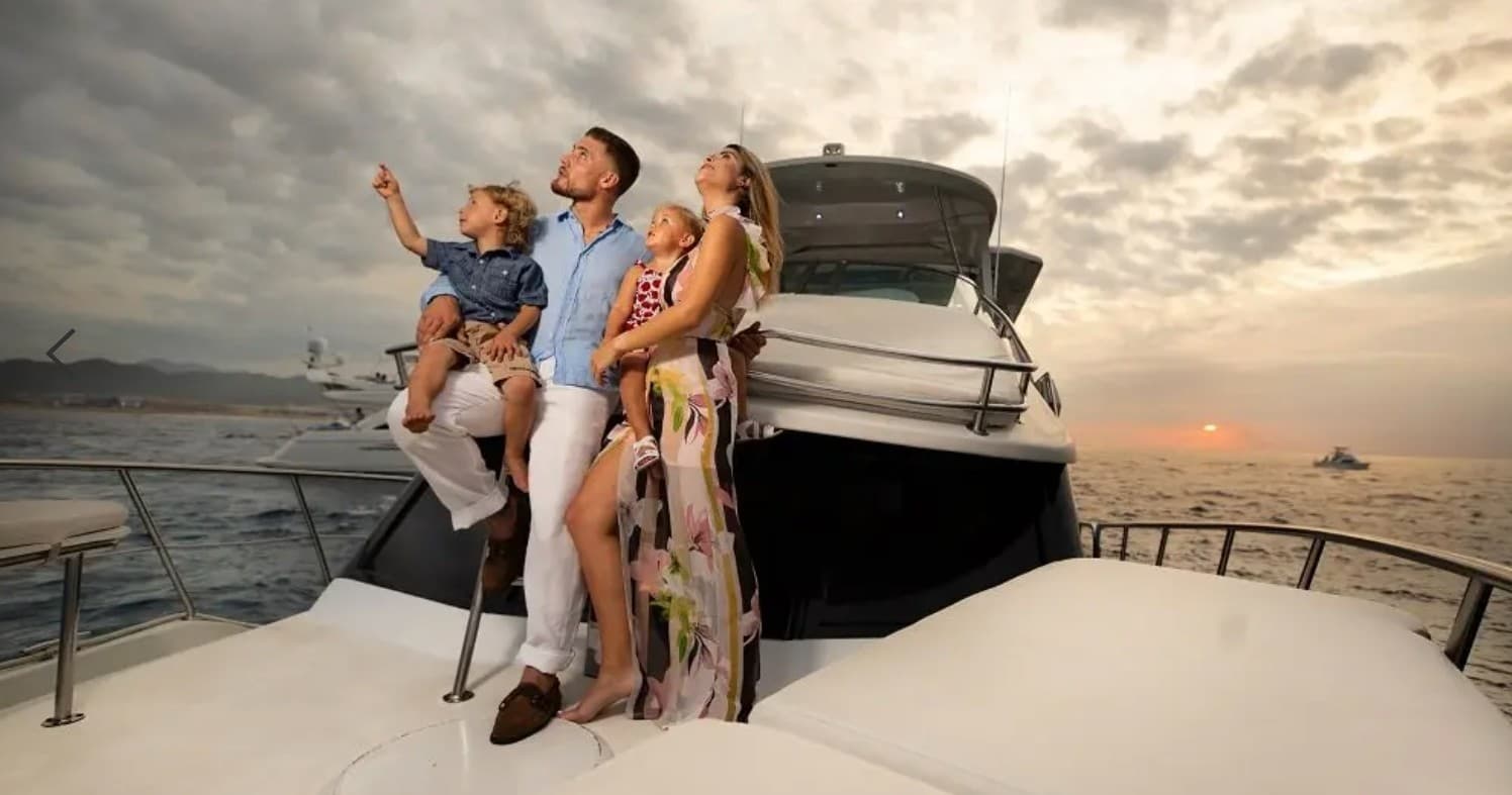 Family enjoying luxury yacht cruise at sunset on open ocean