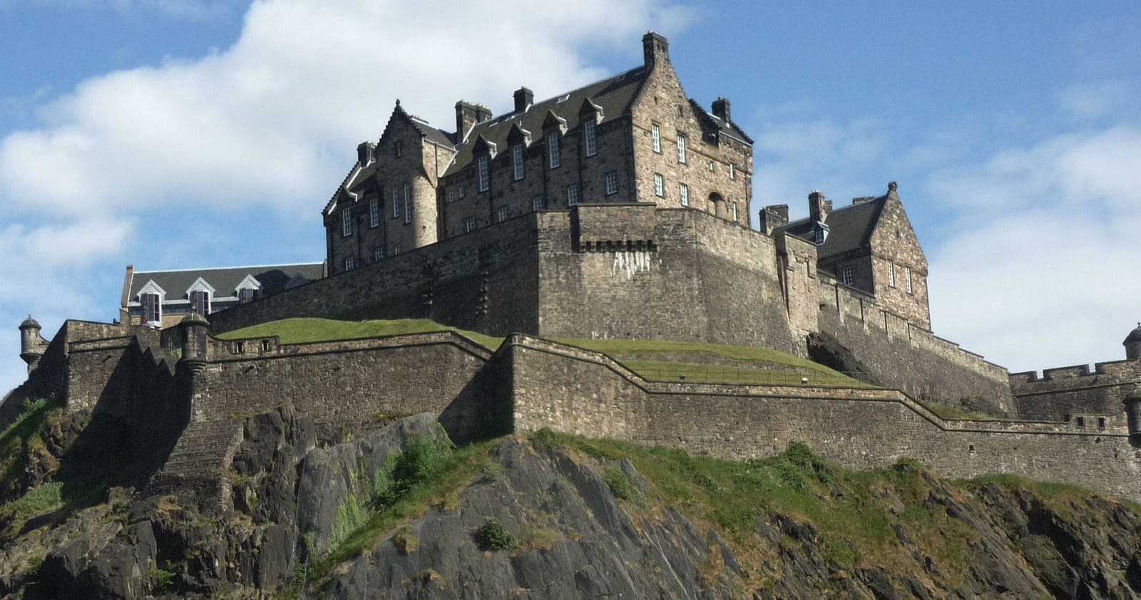 Historic Edinburgh Castle atop volcanic rock showcasing fortress views and tours