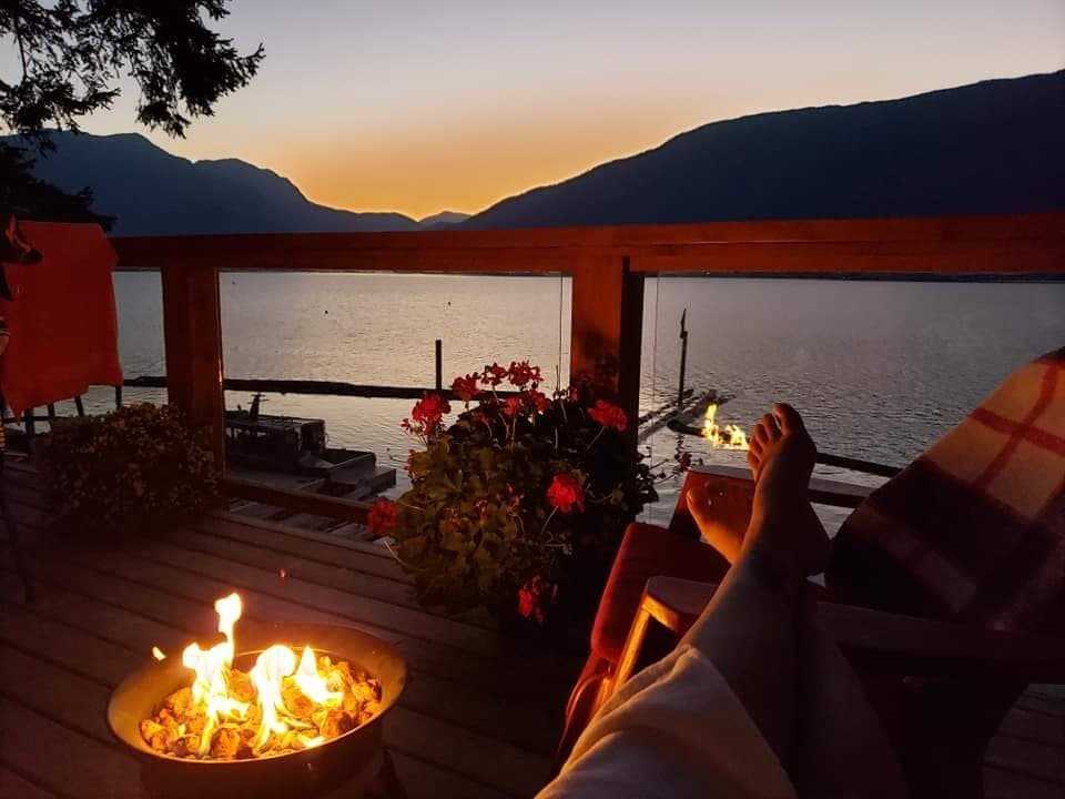 Sunset lakeside deck with firepit and relaxing waterfront view