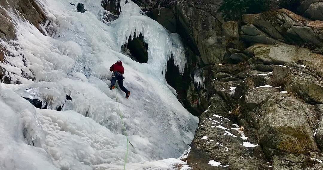 Aerial view of skier descending steep powder in backcountry basin