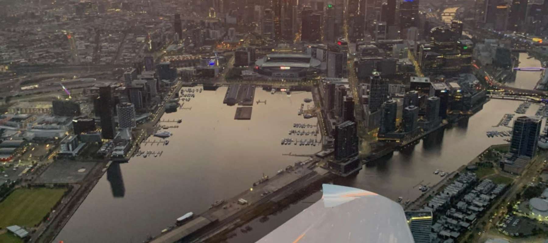 Aerial river and cityscape captured from small aircraft flight