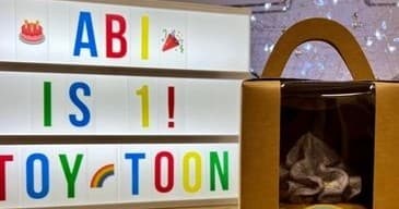 Toytoon marquee sign and gift bag displayed inside indoor toy boutique