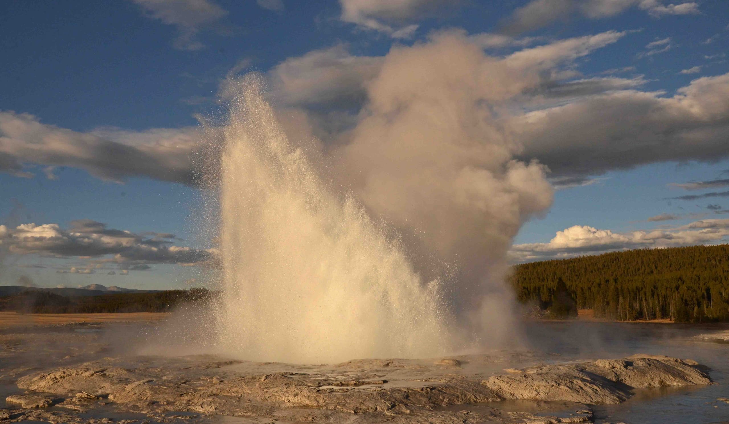 Geyser erupting in Yellowstone National Park, dramatic steam