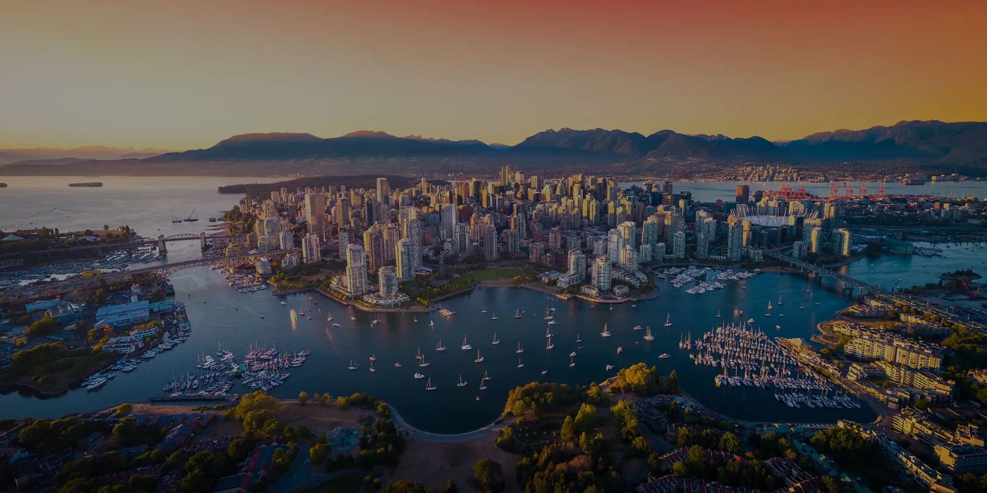 Aerial city skyline and harbor at sunset over coastal bay