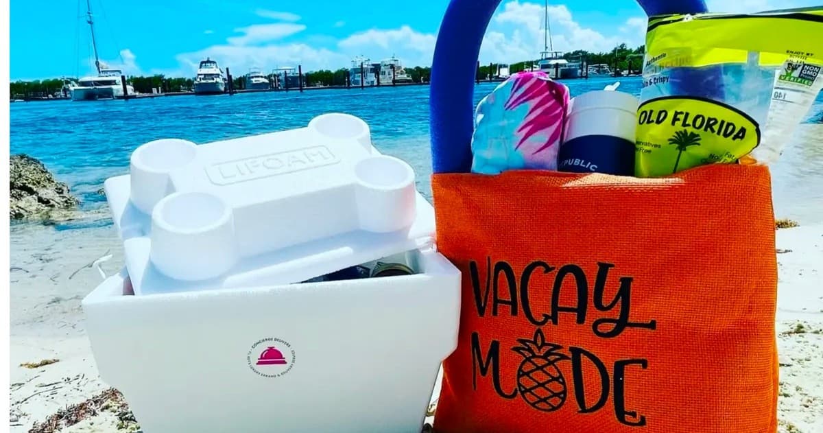 Vacation beach tote and cooler by turquoise bay on sand