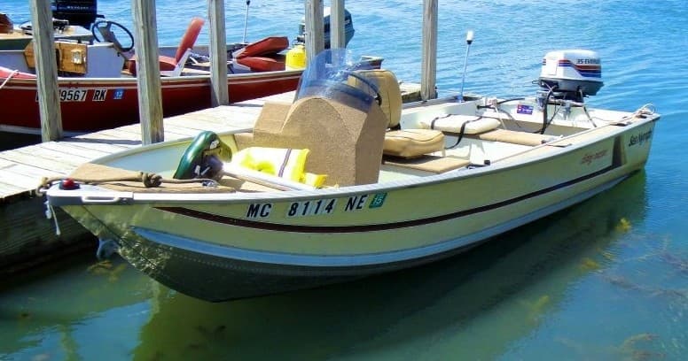 Small fishing boat moored at marina on clear sunny day