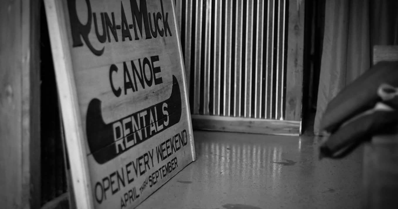Canoe rental sign indoors vintage black and white shop
