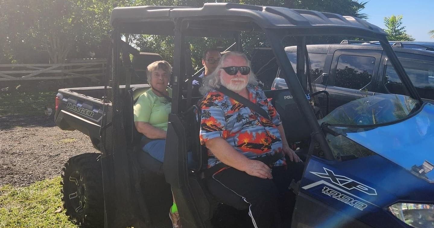 UTV off-road ride on tropical farm trail with two passengers