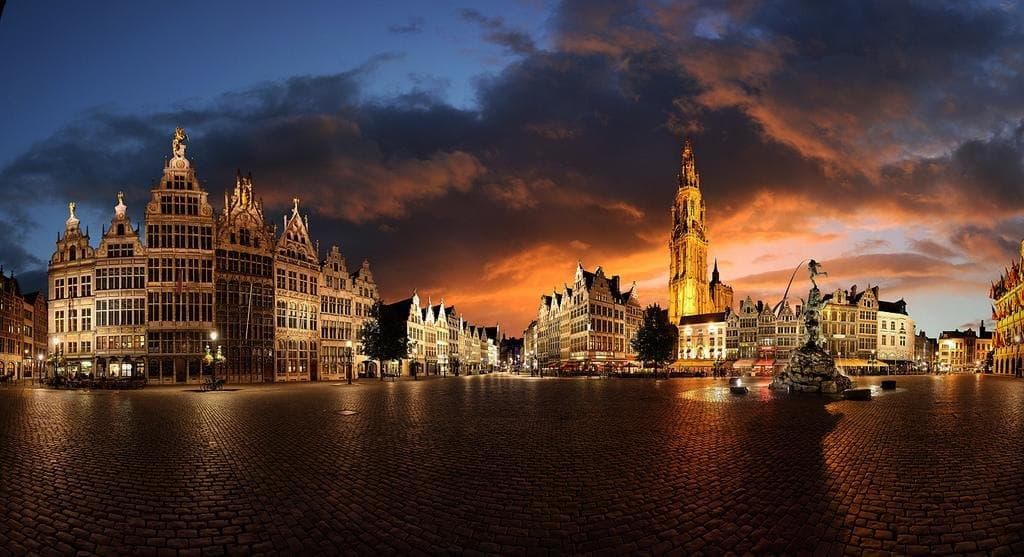 Night waterfront with illuminated guildhouses and reflections