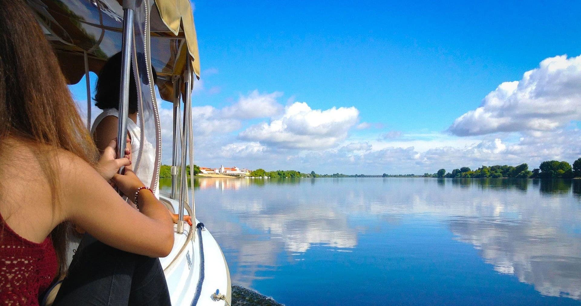 Passengers enjoying a scenic boat ride on calm river