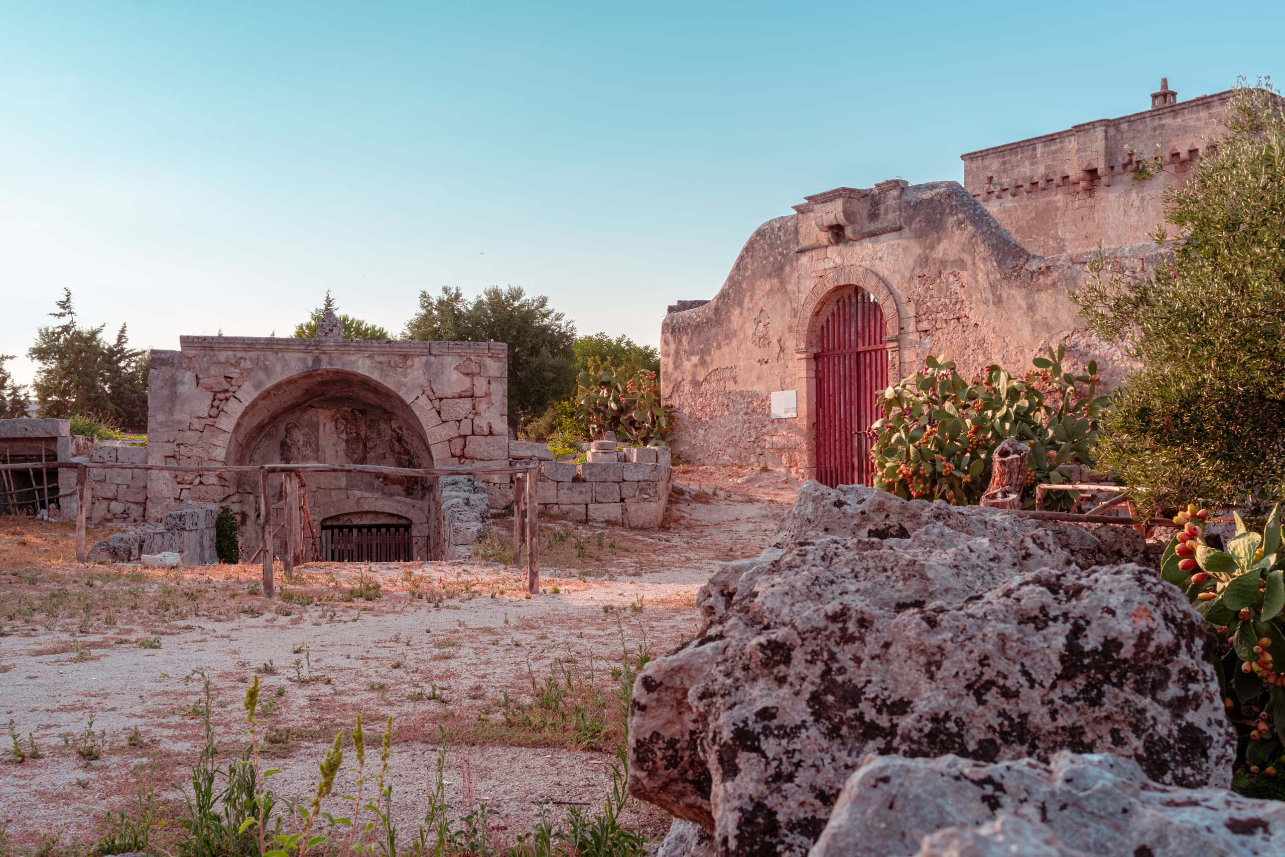 Ancient stone ruins at sunset in rural Mediterranean landscape