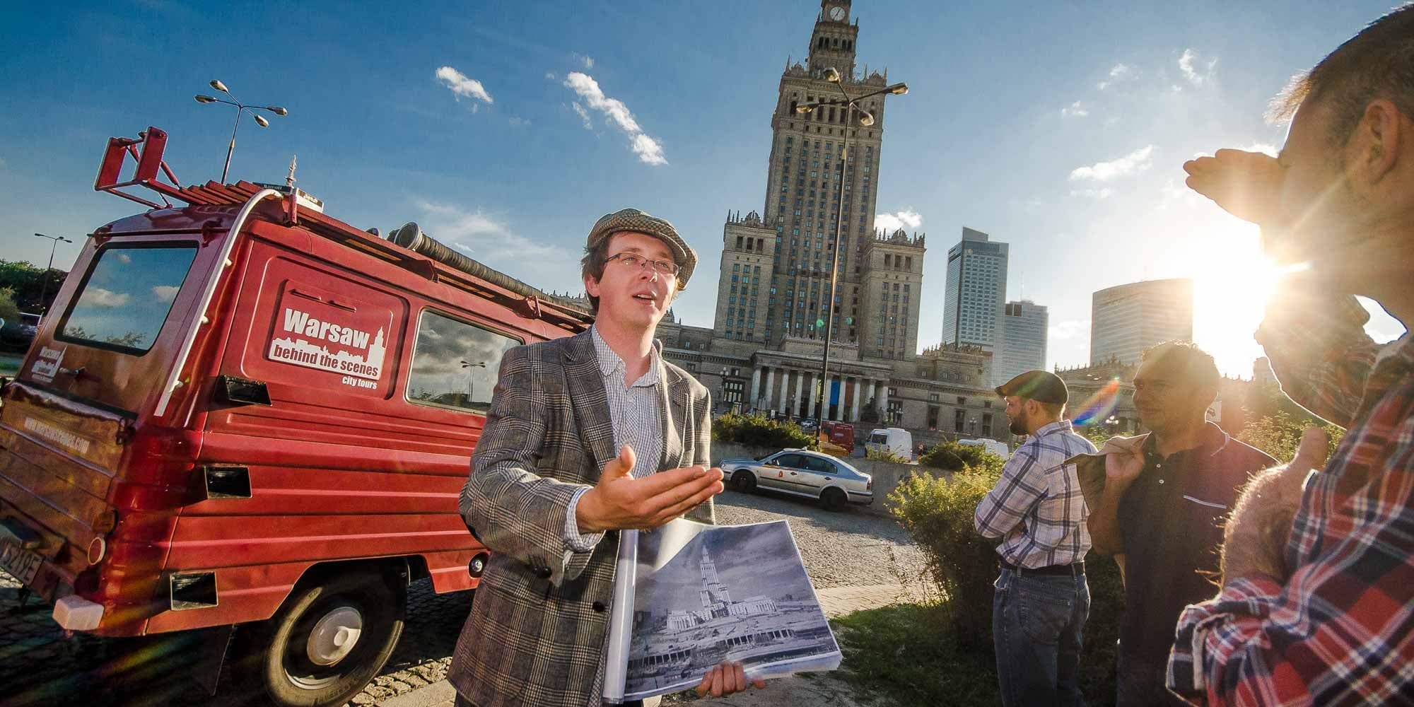 Guide leading walking tour by vintage van near Warsaw city center