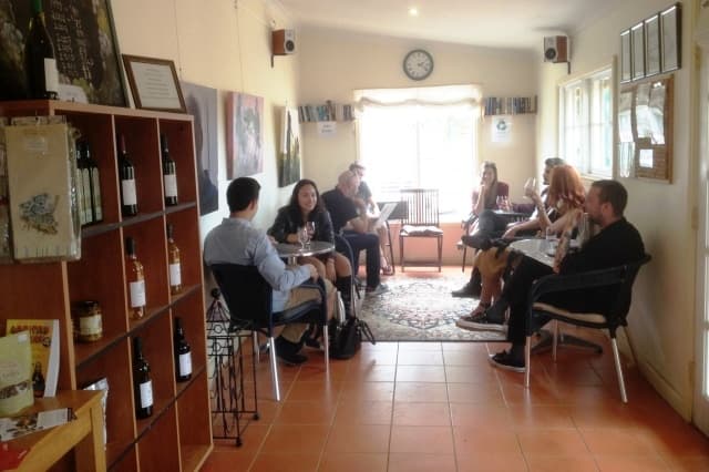 Indoor wine tasting with seated guests in cozy tasting room