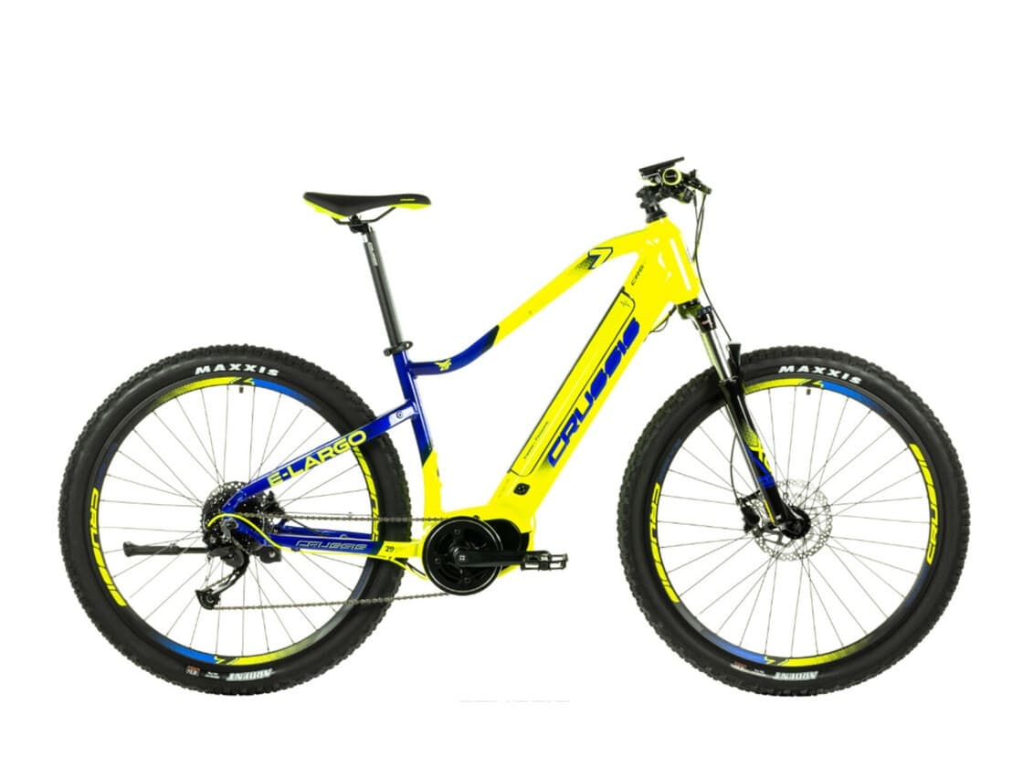 Bright yellow electric mountain bike on white studio backdrop