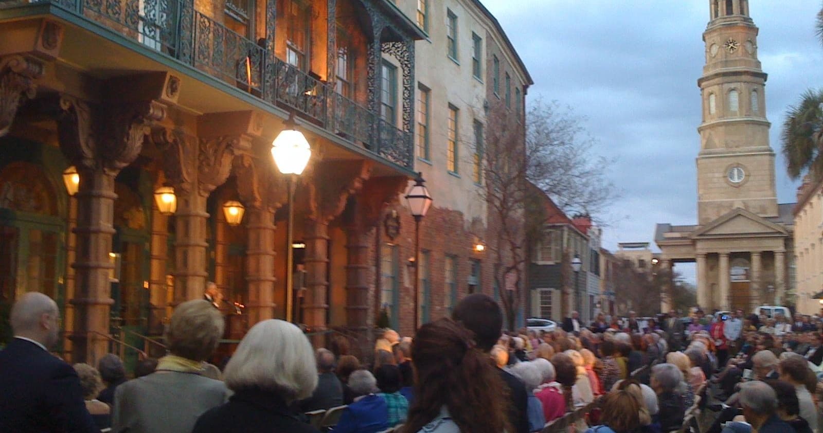 Evening street tour with crowd outside historic Charleston church