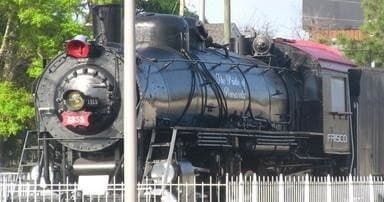 Steam locomotive on display at outdoor heritage railway museum