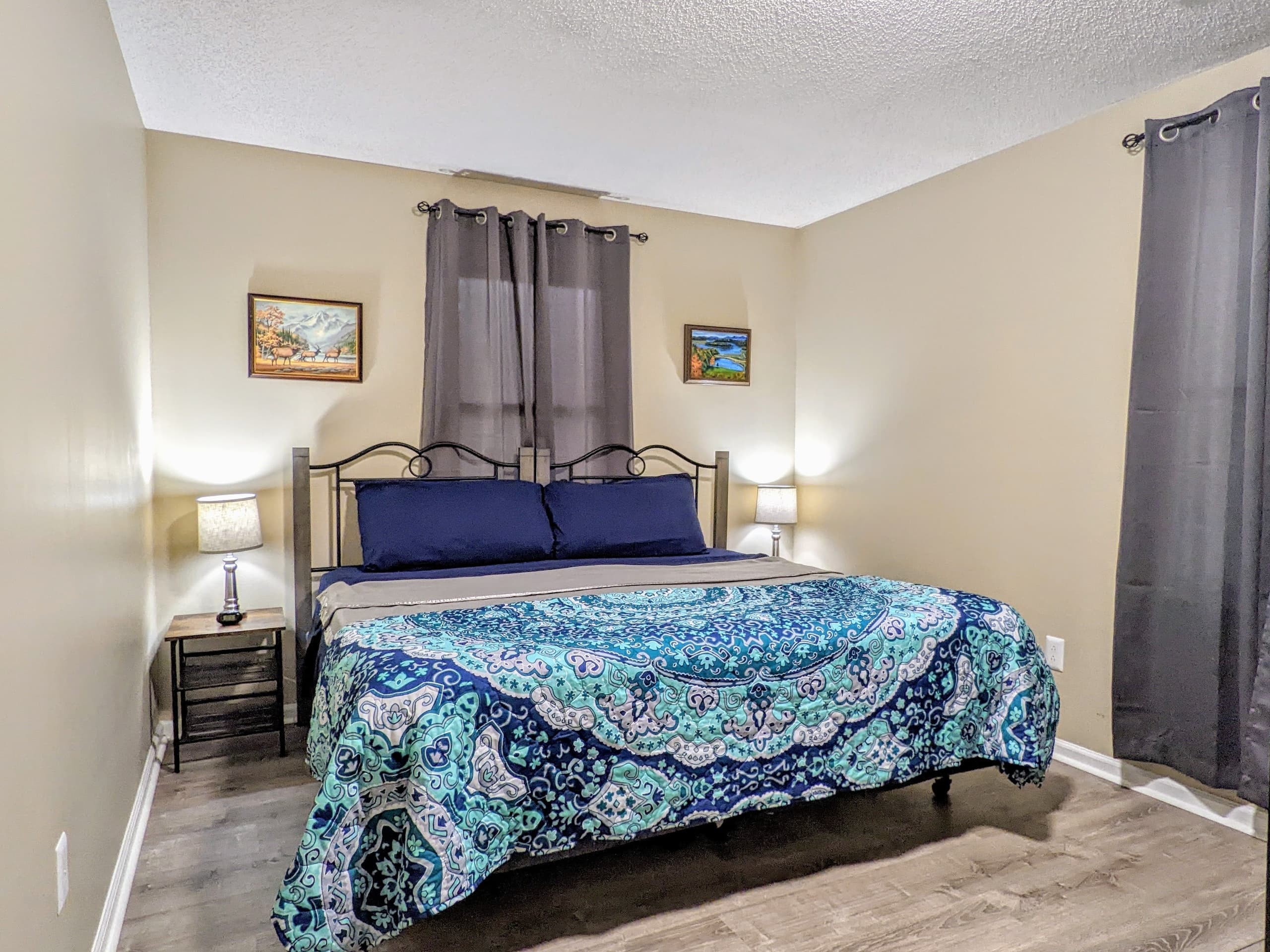 Cozy cabin queen bedroom with scenic window, ideal for hikers