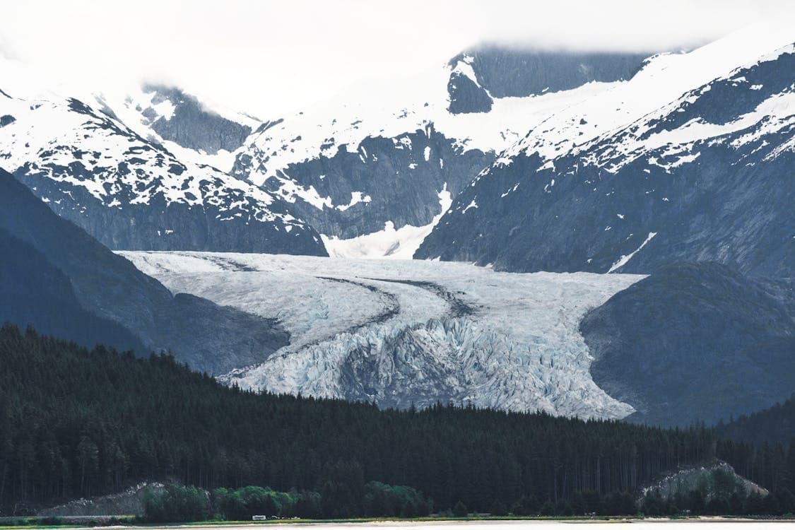 Glacier flowing through alpine valley, ideal for glacier viewing tours