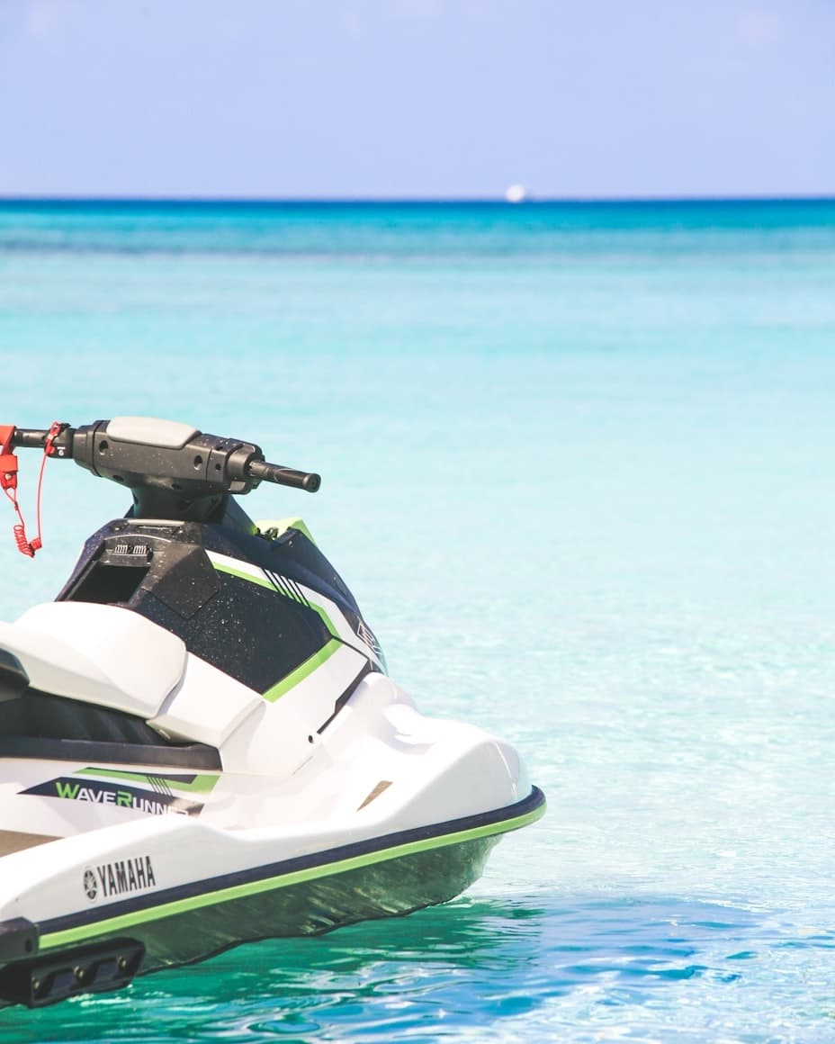 White Yamaha jet ski moored in shallow turquoise tropical ocean