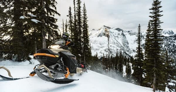 Snowmobile on alpine ridge with mountain vista in Colorado