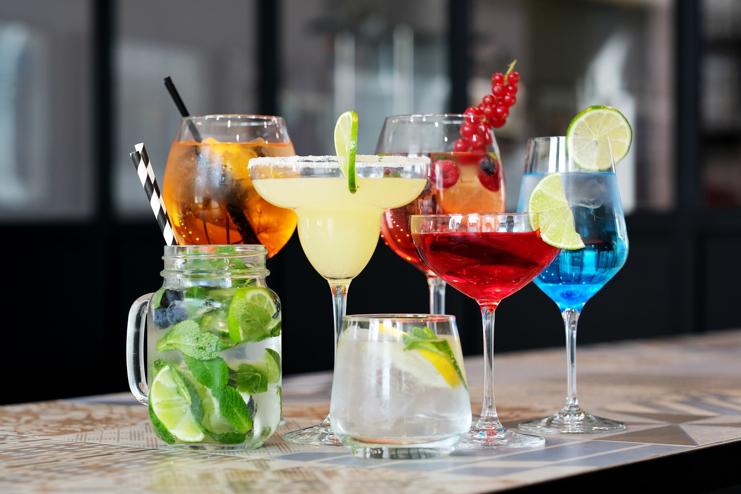 Colorful cocktails and drinks displayed on bar counter for guests