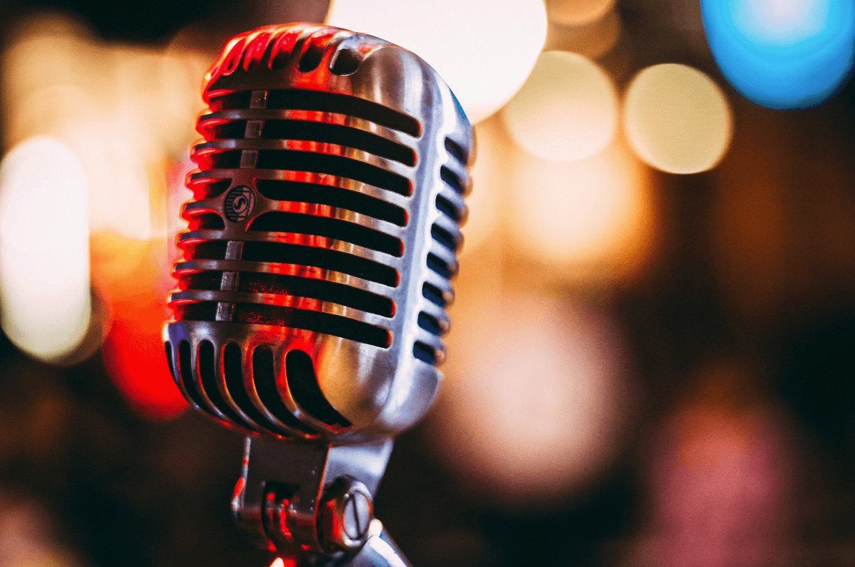 Vintage stage microphone with warm bokeh lights background