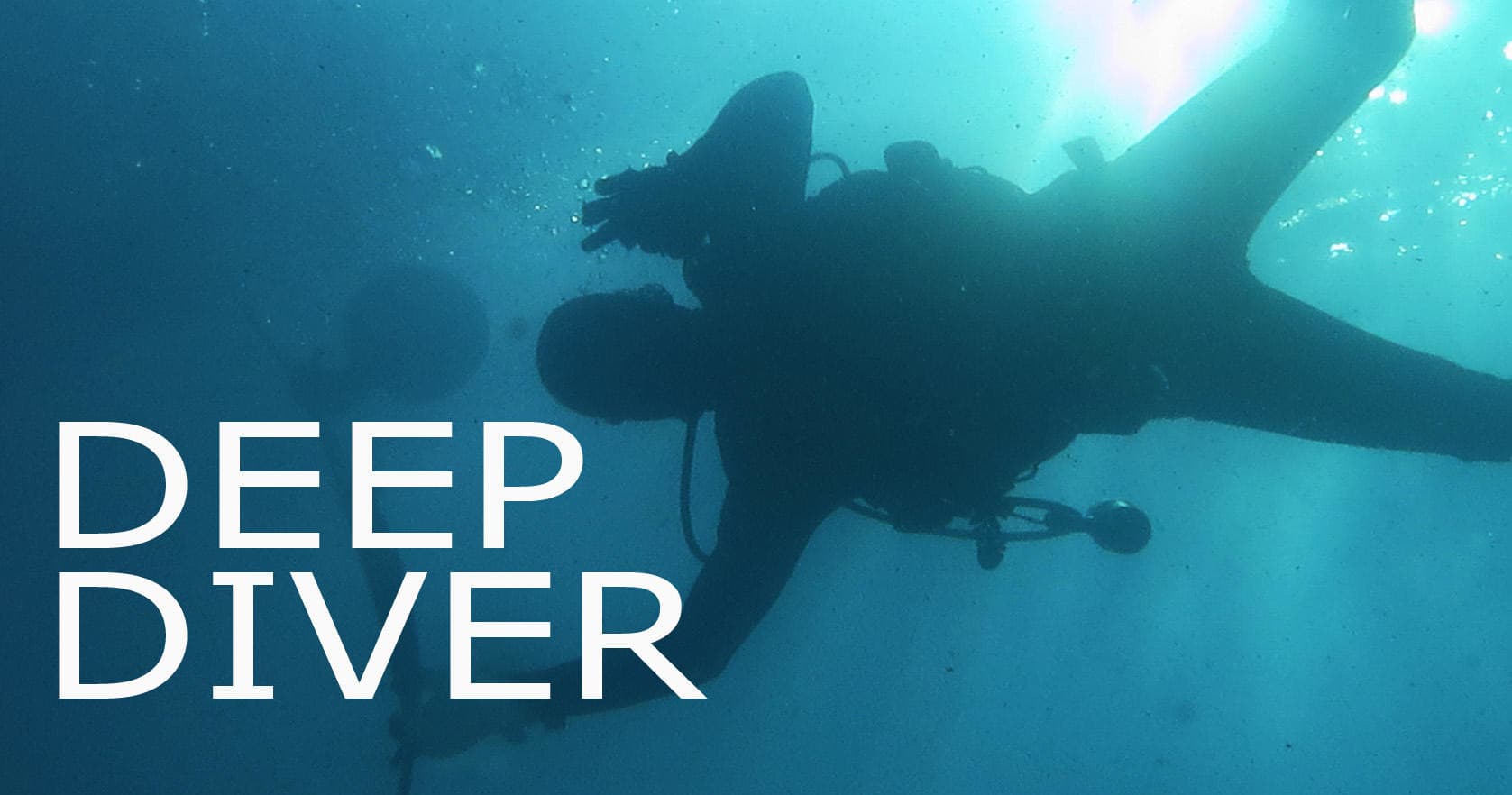 Deep sea diver exploring underwater canyon in tropical waters