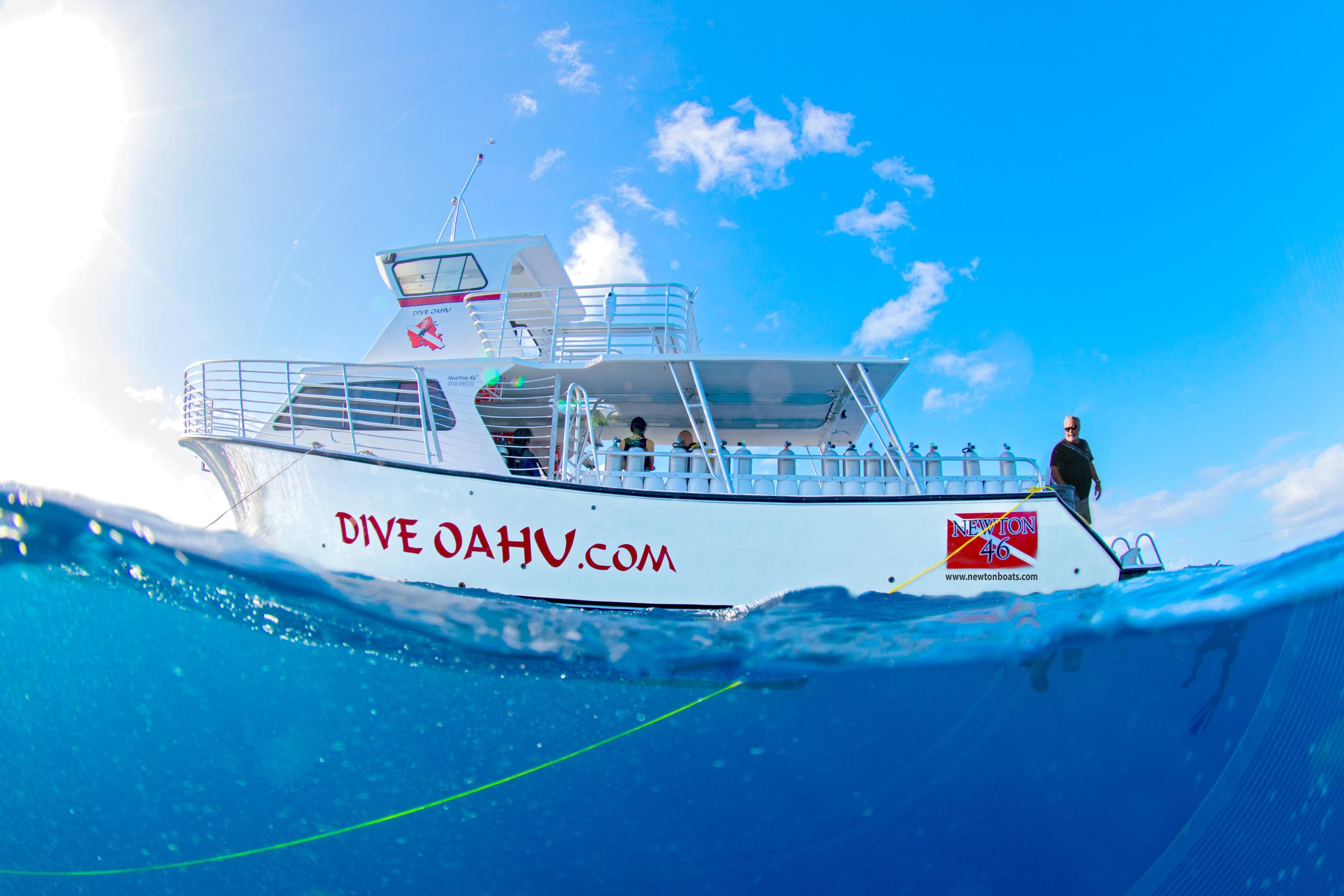 Dive boat on calm Oahu waters under blue sky, inviting trip