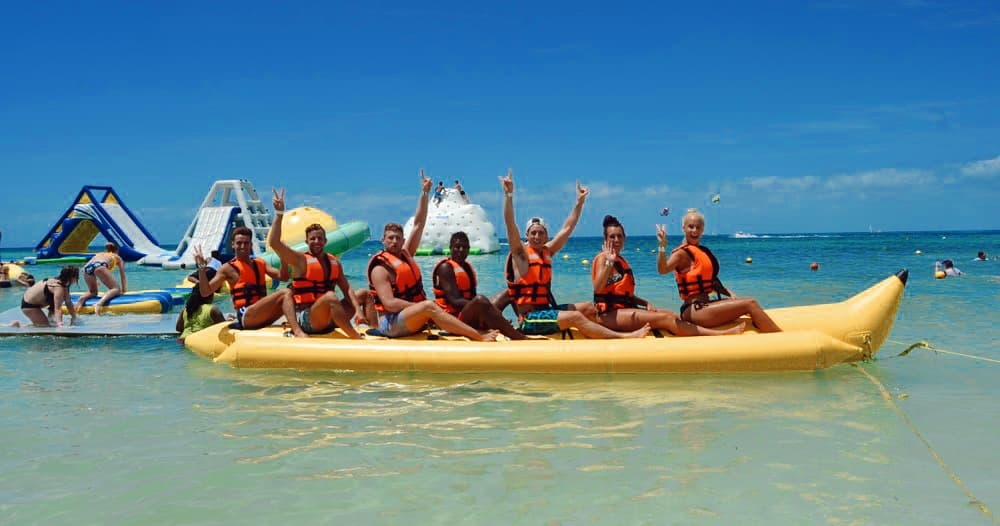 Group on banana boat off Cozumel beach enjoying ocean adventure
