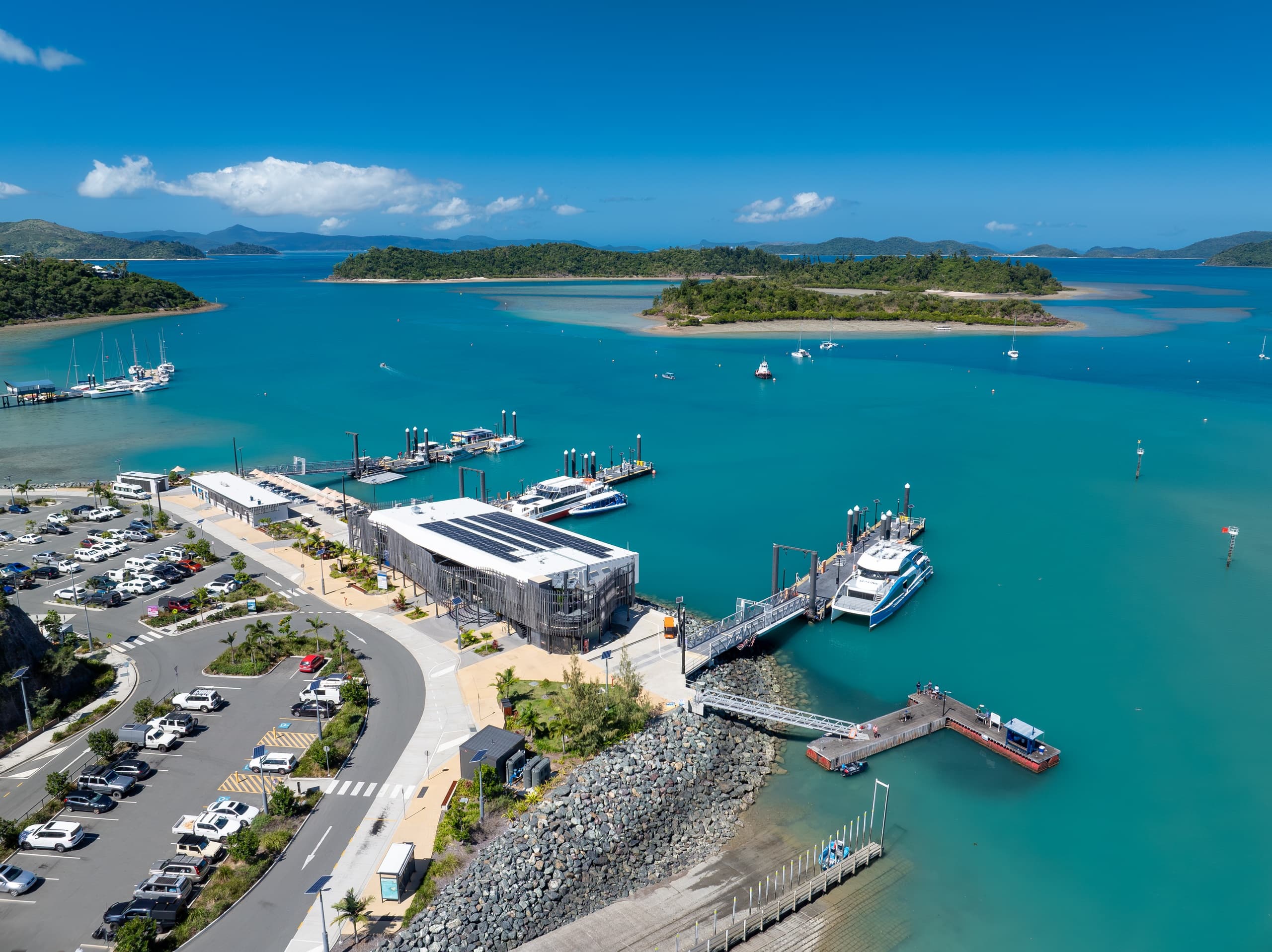 Aerial marina and harbor with docks, boats, and coastal facilities