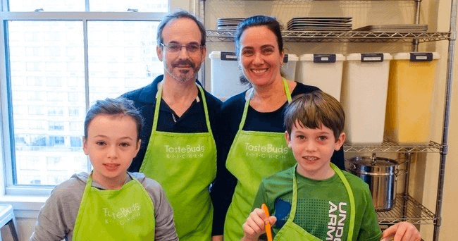 Family cooking class, parents and kids learning in kitchen studio
