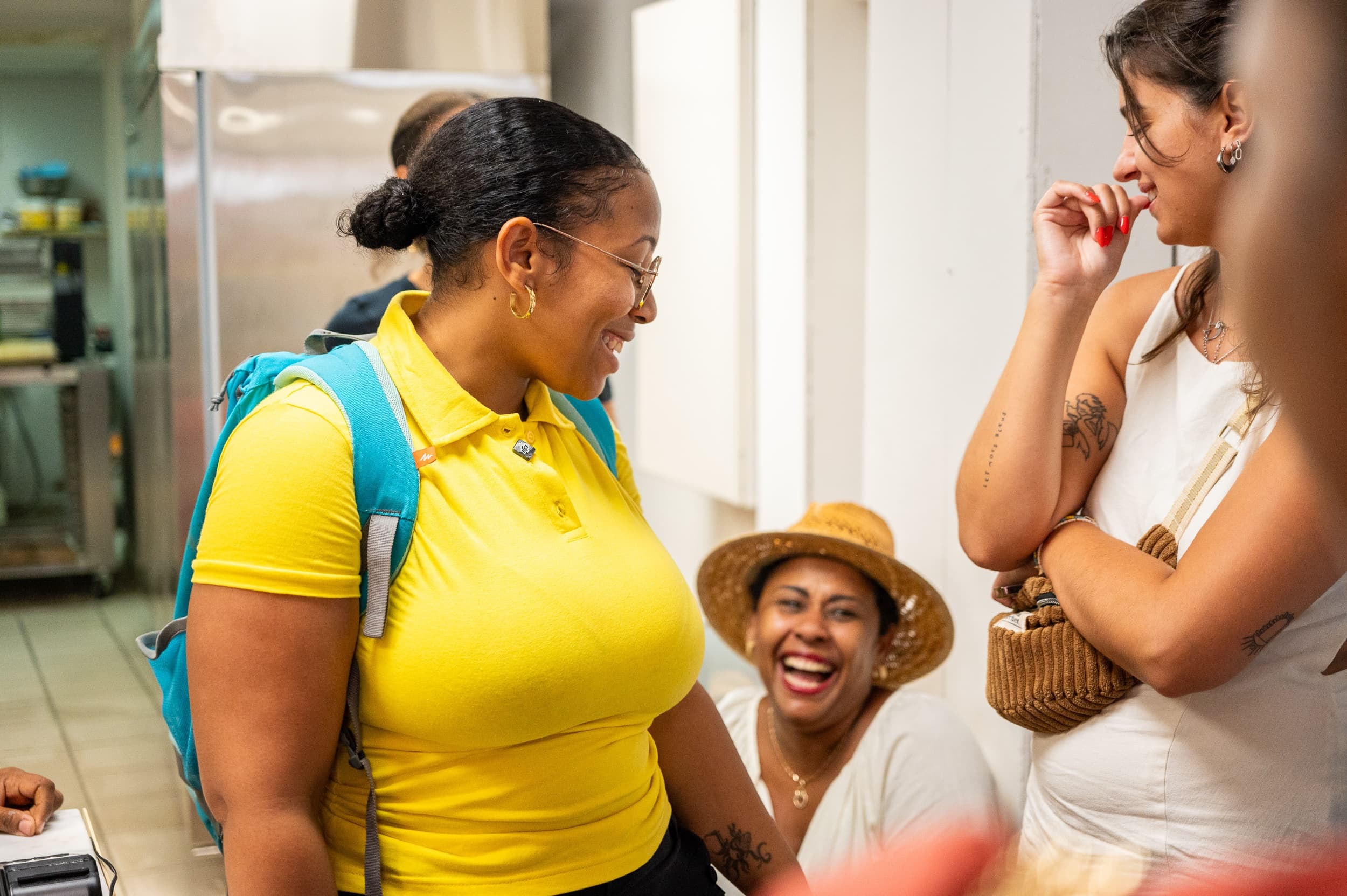 Smiling small group chatting in kitchen basecamp during culinary tour meetup