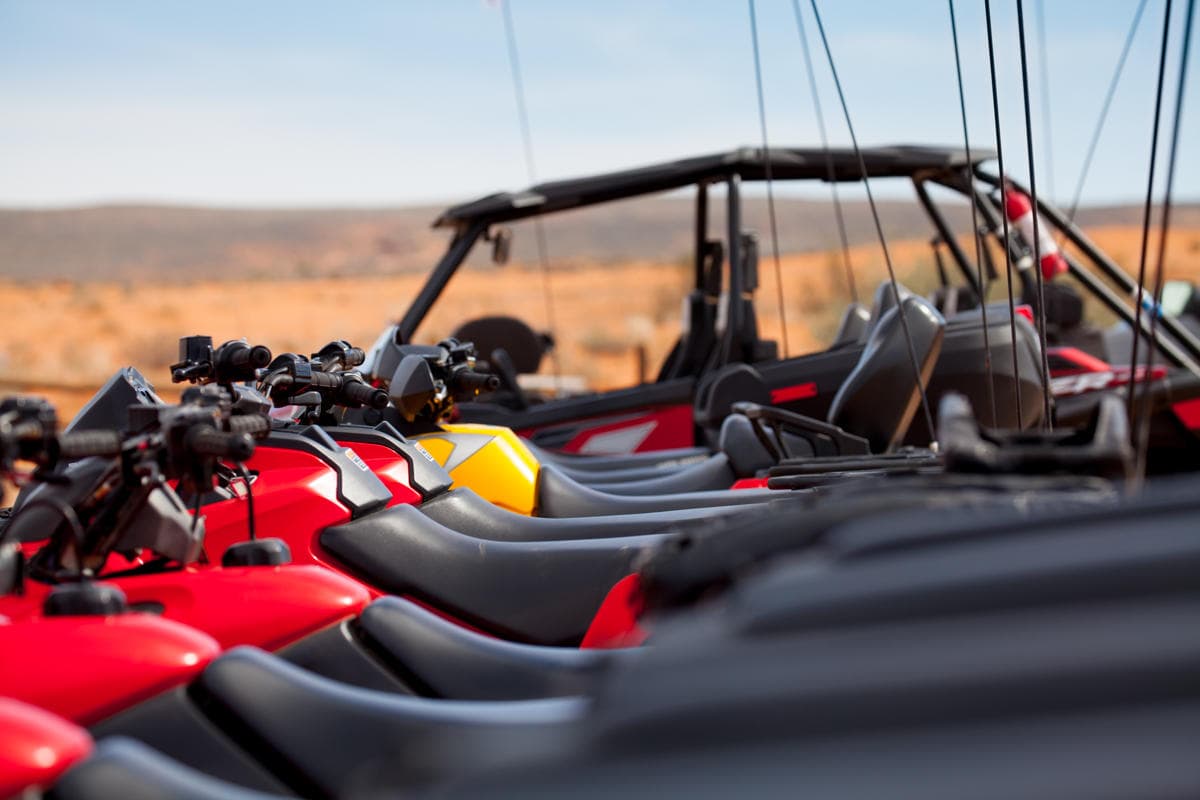 Dawn UTV lineup on red dunes showcasing guided desert rides
