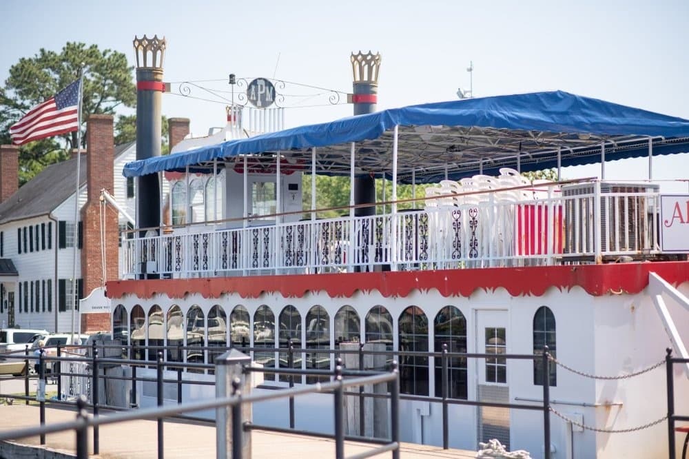 Historic riverboat docked at waterfront pier for scenic cruises