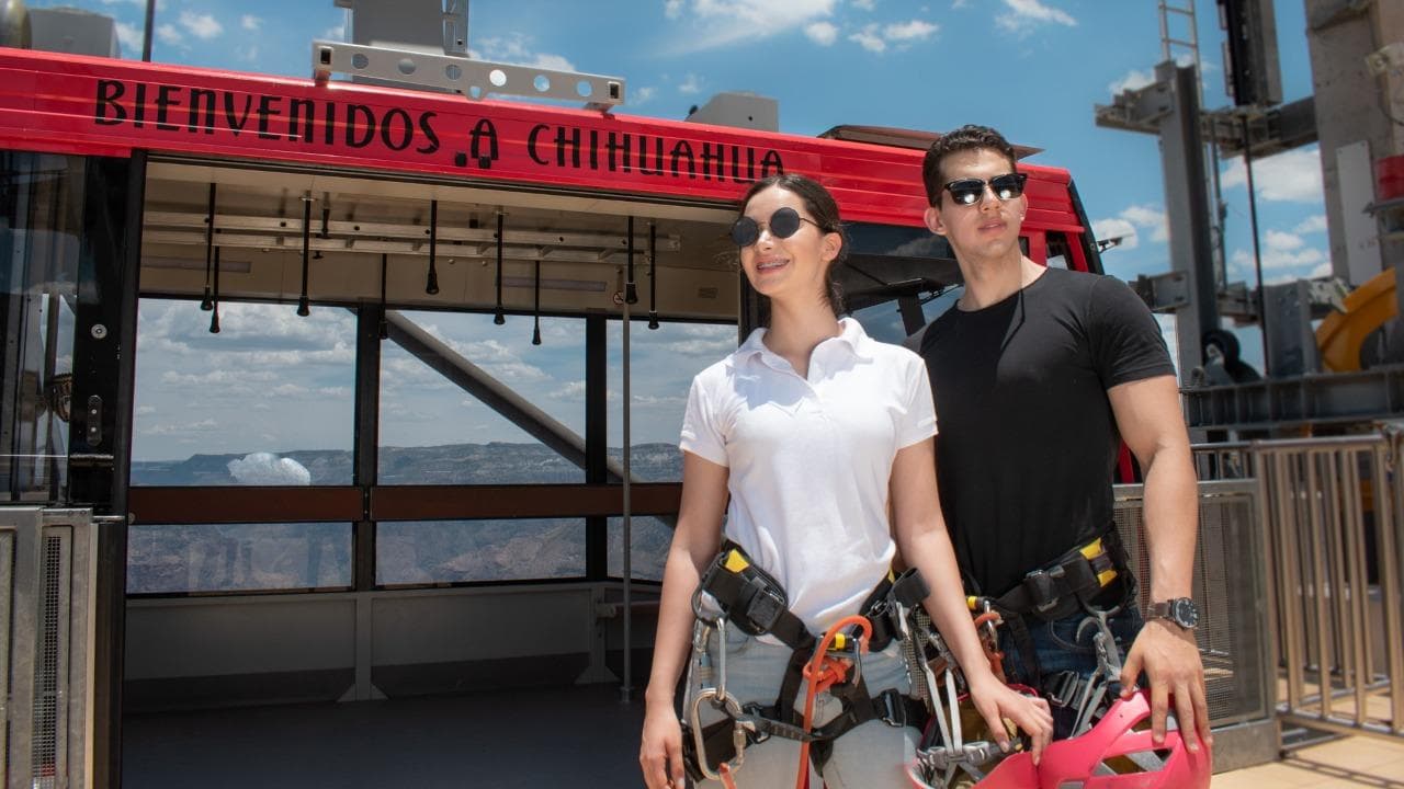 Couple gearing up on launch platform with canyon background in Chihuahua